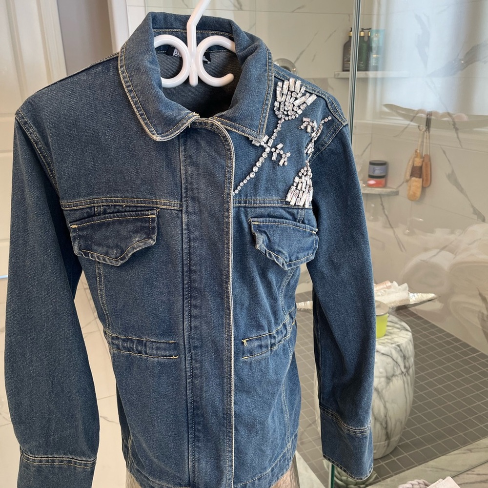 A Safari styled denim jacket with rhinestones size small zippered front
